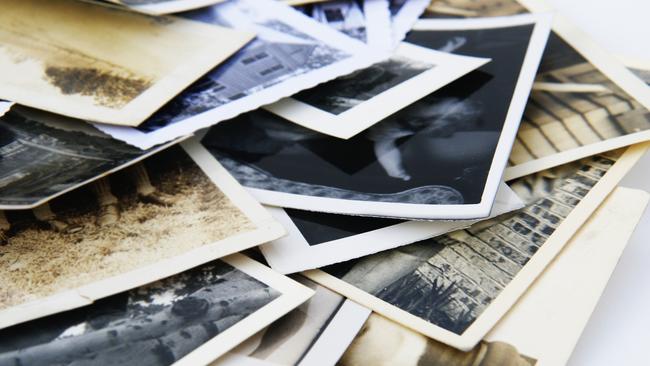 Old vintage and retro photographs in a pile.  These could be candid snapshots with nothing recognizable in any of the photographs.   This group of photos is full of memories and sentimentality.  Uses are scrapbooking, memory problems, family history and family tree projects among many others.