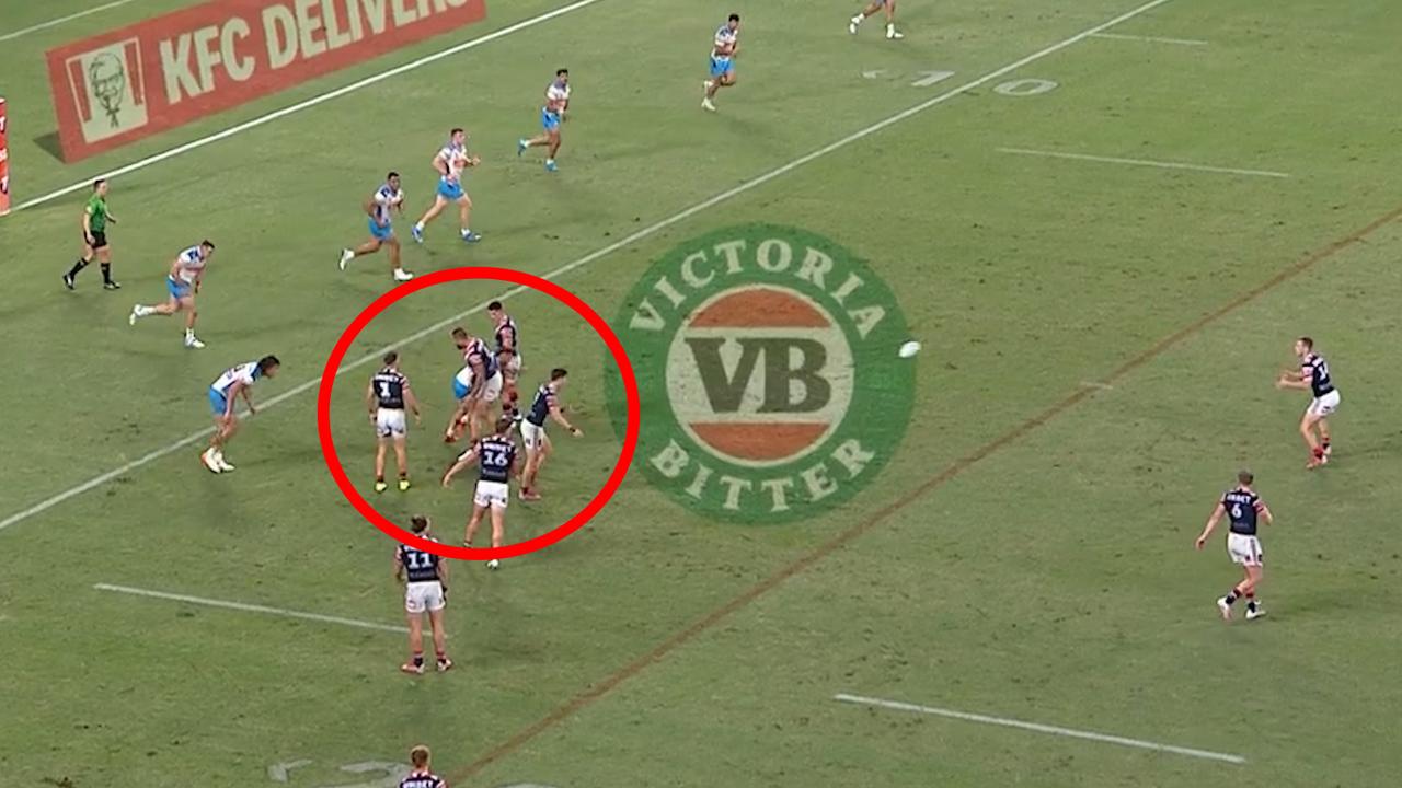 The Roosters form a wall as Sam Walker kicks a field goal.