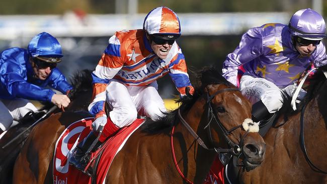 NCA. MELBOURNE, AUSTRALIA. October 12 , 2024. RACING. Caulfield Guineas race day at Caulfield Racecourse  .  Race 9. The Schillaci Stakes.  Craig Williams (orange and white cap) urges Bellatrix Star on as he charges to the post to win race 9  .  Pic : Michael Klein