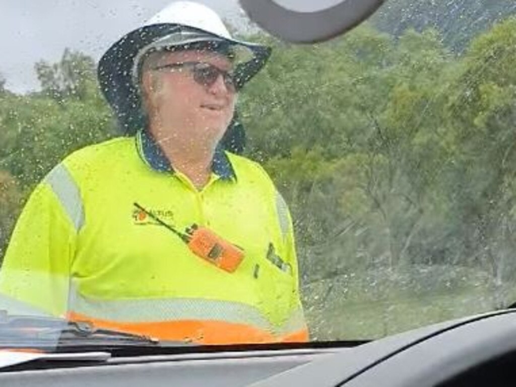 The bemused traffic controller comes to the rescue to remove the snake. Picture: Supplied