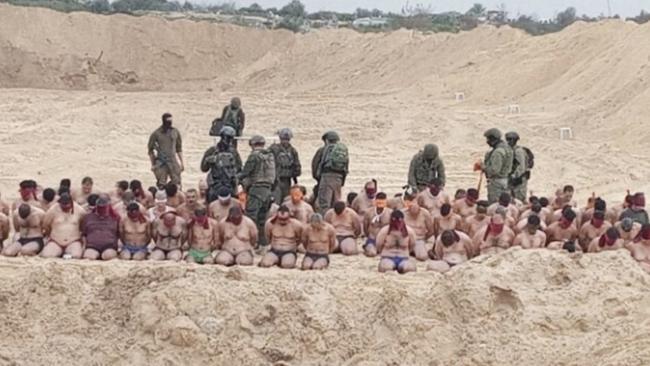 IDF troops guard Palestinian prisoners. Picture: Channel 12.