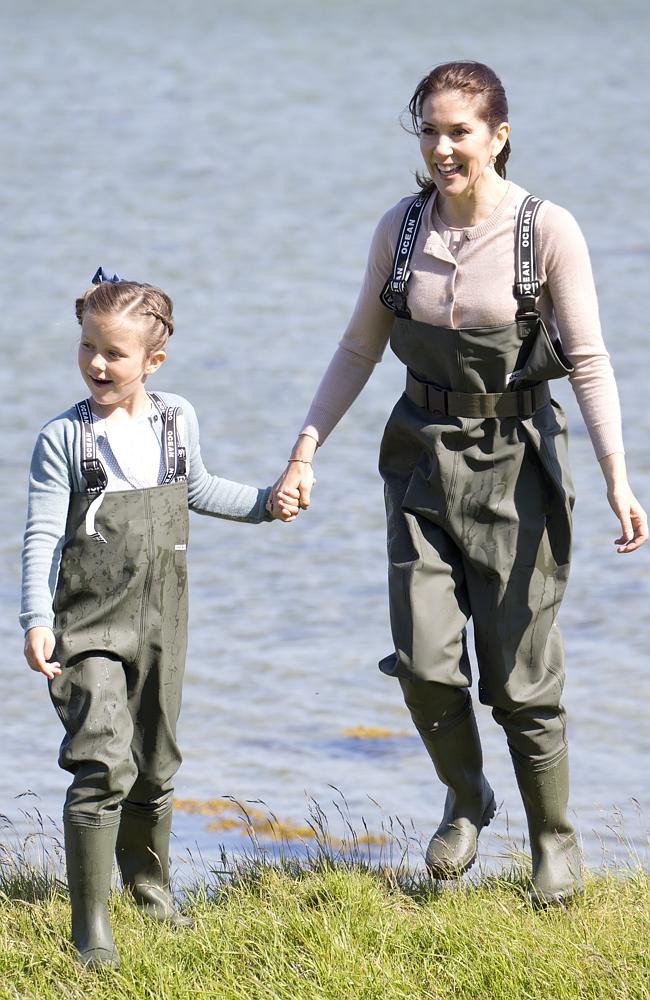 <p>In matching muted-toned cardigans Princess Isabella of Denmark, accompanied by her mother Crown Princess Mary of Denmark visits a nature school, and view fish and shrimps in the estuary, during her first day of official engagements. Picture: Getty</p>