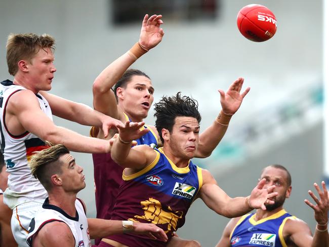 BRISBANE, AUSTRALIA - JUNE 28: Cam Rayner of the Lions (center) competes for the ball during the round 4 AFL match between the Brisbane Lions and the Adelaide Crows at The Gabba on June 28, 2020 in Brisbane, Australia. (Photo by Jono Searle/AFL Photos/via Getty Images ) *** BESTPIX ***