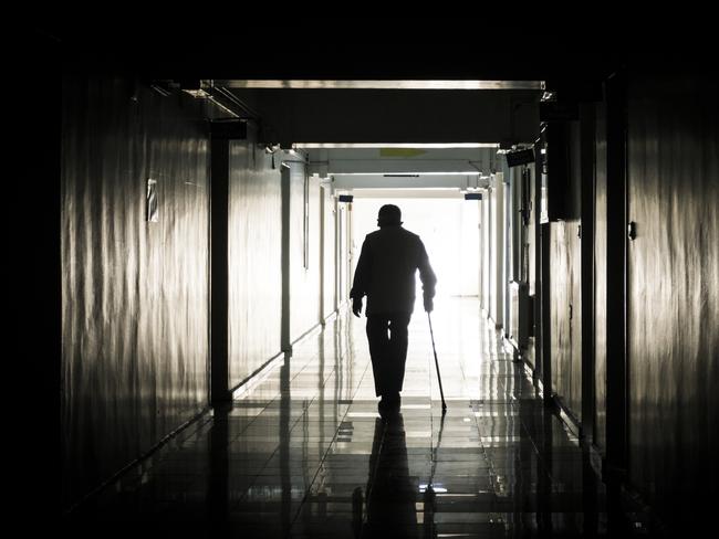 Disabled senior man walking with stick