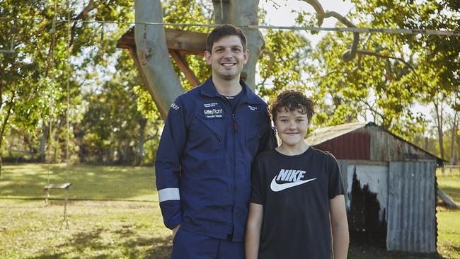 LifeFlight Critical Care Doctor Richard Parker with Eli Jarick – the 13-year-old boy he saved at Pine Creek near Bundaberg in front of the tree Eli fell six metres from.
