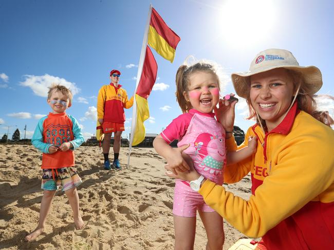 Surf lifesavers Alex Schwarcz [rear] and Jess Sincock [front] with kids Archie and Sophie Calder, 4 and 3. Picture: Alex Coppel