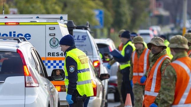 Australian Army soldiers assist New South Wales Police Officers at the Wodonga Place border control point in Albury, during Operation COVID-19 Assist.