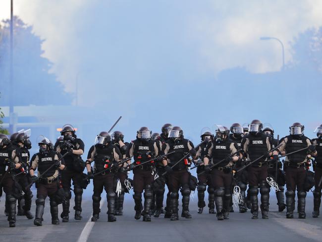 FILE - In this May 30, 2020, file photo, state patrol clears an area after curfew in Minneapolis. In the two weeks since George FloydÃ¢â&#130;¬â&#132;¢s killing, police departments have banned chokeholds, Confederate monuments have fallen and officers have been arrested and charged. The moves come amid a massive, nationwide outcry against violence by police and racism. (AP Photo/Julio Cortez, File)