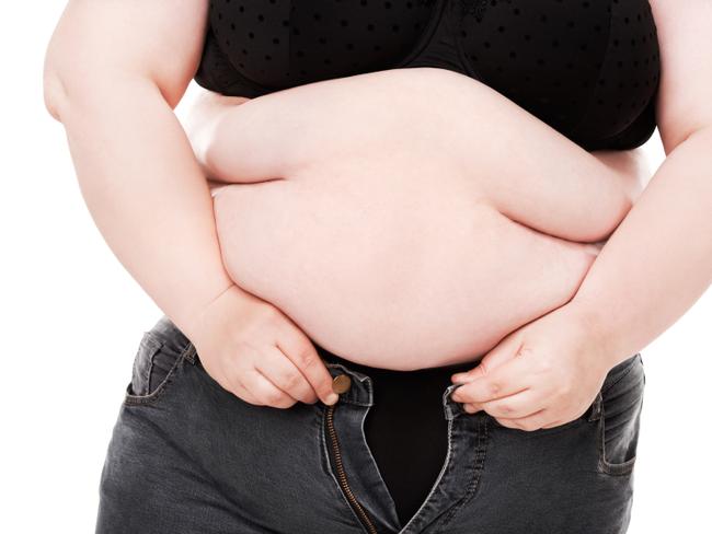 RendezView. Overweight woman trying desperately to fit into a pair of jeans that are too small. (Pic: iStock)