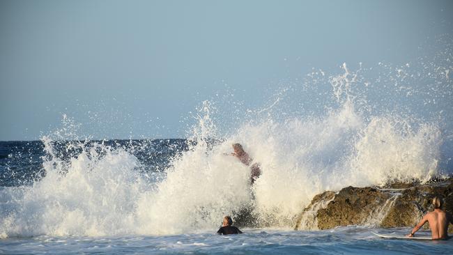 Young swimmers knocked down by swell at Snapper Rocks on the Gold Coast generated by Tropical Cyclone Oma. Picture: Mark Furler