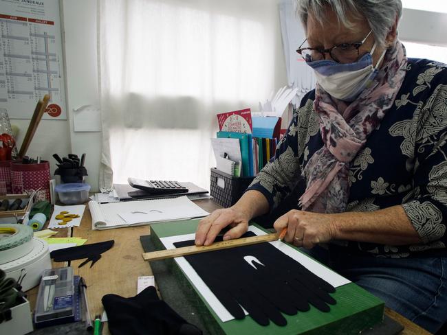 A seamstress works on a glove at the atelier of the French luxury fashion company Agnelle. The luxury goods market has been hard-hit by COVID-19. Picture: AFP