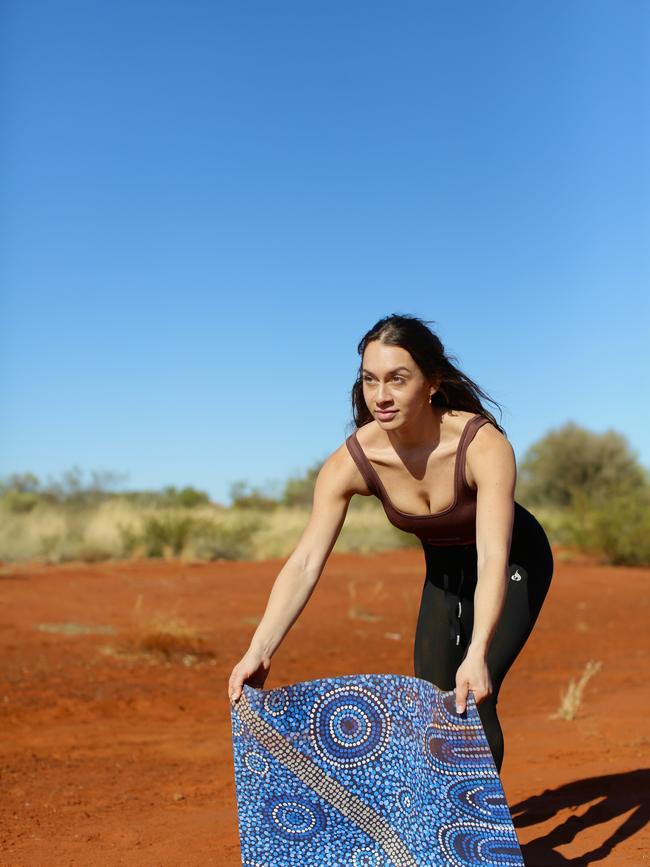 Mariah Torres Akamarre with one of the yoga mats she designs and sells.