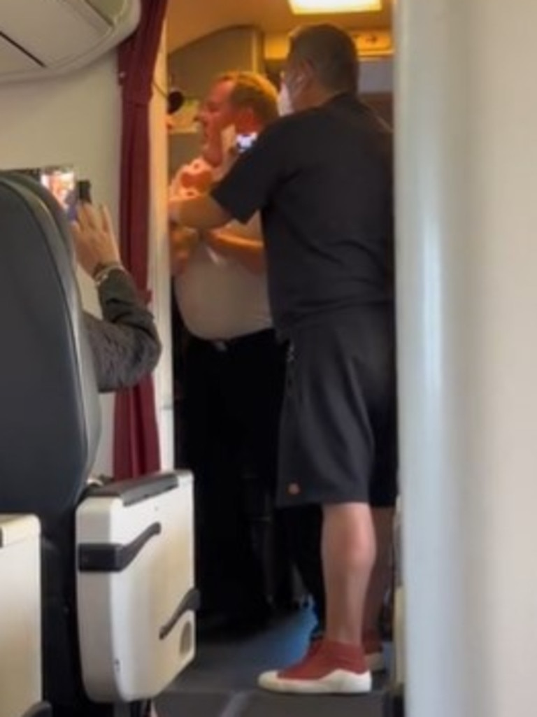 The man was pushed off the flight by the pilot, a flight attendant and fellow passenger. Picture: TikTok / @_benmckay