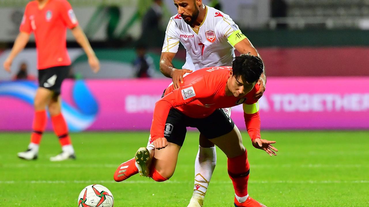 South Korea's forward Heung-min Son (C) is challenged by Bahrain's midfielder Abdulwahab Al Safi (R)
