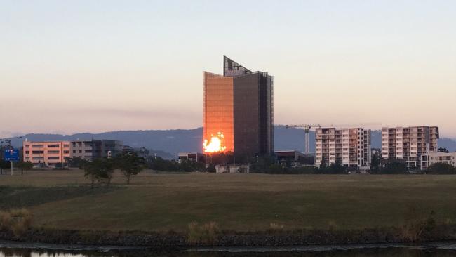 Sunrise reflecting off The Rocket building in Robina. Photo: BARRY BEVERIDGE, Robina.