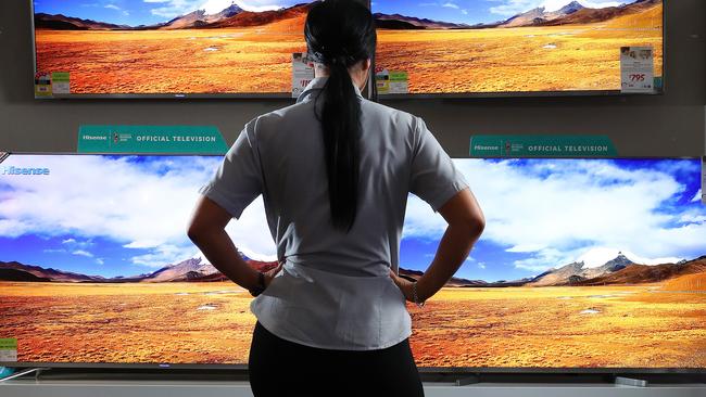 A woman looking at televisions for sale, Harvey Norman, Homemaker Centre, Newstead. Photographer: Liam Kidston.