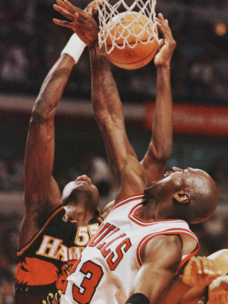 Mutombo fights Michael Jordan for a rebound.