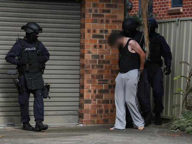 Heavily-armed police arrest one of the brothers in January last year. Picture: NSW Police Media