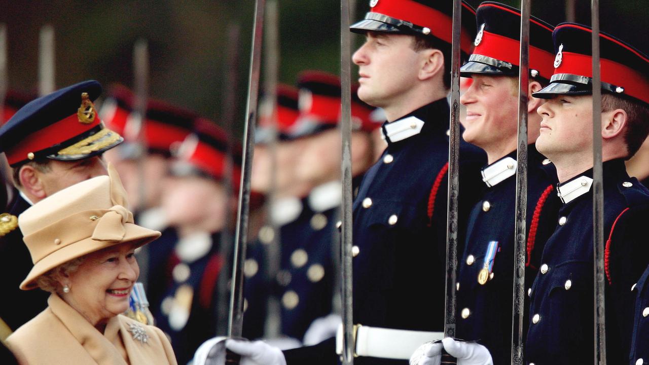 <b>2006: </b>Prince Harry graduates from Sandhurst Military Academy, smiling as his grandmother, Queen Elizabeth, inspects the military parade. The graduation marks the culmination of Prince Harry’s lifelong dream of serving his country.