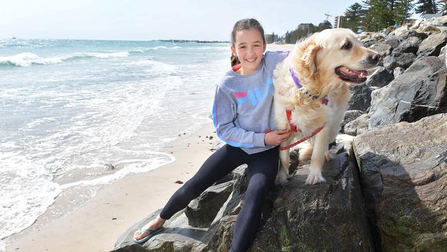 Compassion for animals motivated St Thomas School student Jess, 12, of Clovelly Park to make an award-winning 3minute video about climate change, pictured at Glenelg beach with her dog Rosie. Picture: Mark Brake.