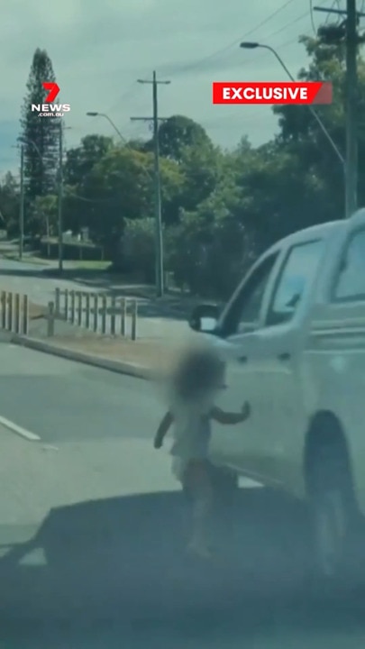 Toddler narrowly misses car
