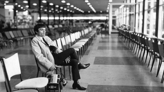 Jimmy Nicol, part of the rapturous welcome to Melbourne for The Beatles a day earlier, waits for a plane on his own at Essendon Airport. Picture: HWT Library