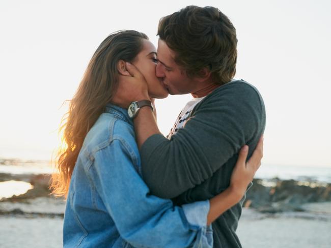 Shot of an affectionate young couple bonding at the beachCouple kissing at the beachRomance and love at the beachPicture: iStock