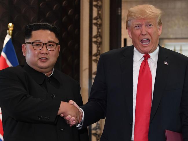 (FILES) In this file photo taken on June 12, 2018 US President Donald Trump (R) and North Korea's leader Kim Jong Un shake hands following a signing ceremony during their historic US-North Korea summit, at the Capella Hotel on Sentosa island in Singapore. News that North Korea appears to be building more intercontinental missiles does not necessarily mean negotiations between Washington and Pyongyang are headed for trouble, experts said on July 31, 2018. Just weeks after President Donald Trump and North Korean leader Kim Jong Un met at a high-stakes summit in Singapore, officials told the Washington Post that Pyongyang seems to be developing at least one or two liquid-fueled intercontinental ballistic missiles. The work is underway at a factory outside Pyongyang in Sanumdong, where scientists produced the North's first ICBMs capable of reaching the United States.  / AFP PHOTO / SAUL LOEB