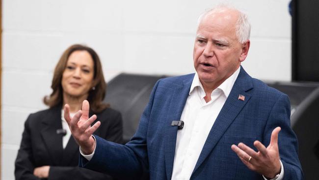 Democratic presidential candidate US Vice President Kamala Harris listen to her running mate, Governor Tim Walz.