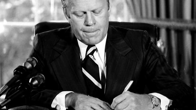 US president Gerald Ford signs the document former president Richard Nixon ‘full, free and absolute pardon’ for ‘offences against the United States’ at the White House in September 1974.