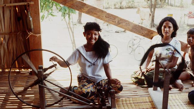 Women spinning yarn in Cambodia.