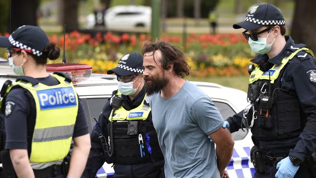 Police arrest a person outside Government House in Melbourne. Picture: NCA NewsWire / Andrew Henshaw