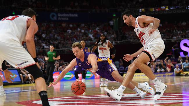 Kings star Brad Newley dives to recover the ball during Sydney’s win over the Hawks. Picture: AAP