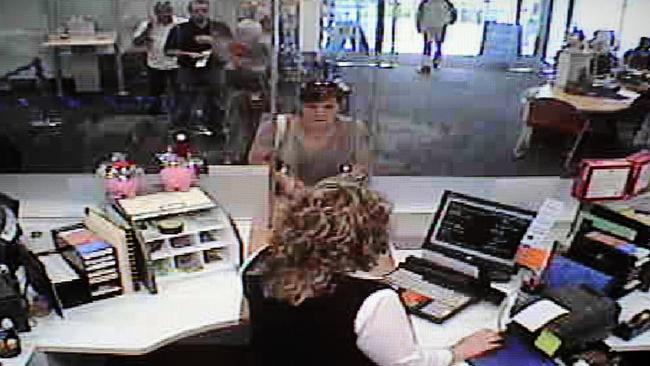 Gavare, centre, captured on CCTV trying to access Ms McGlynn’s account at the ANZ branch at Morphett Vale in December 2008. Picture: Supplied