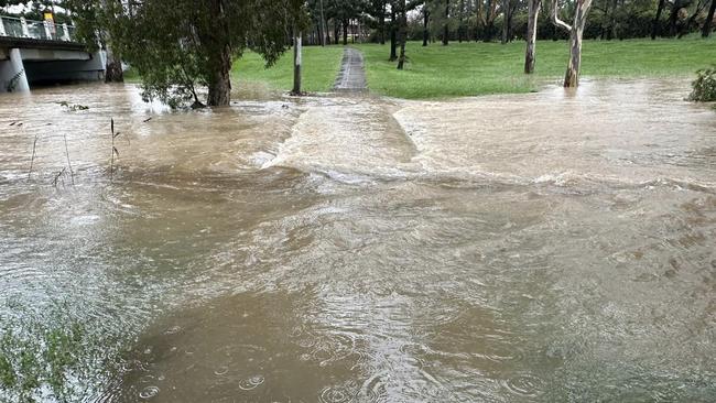 Floodwater covers Deebing Creek footbridge in Ipswich on Saturday. Picture: David Martin/Facebook