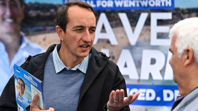 Liberal member for Wentworth Dave Sharma speaks to voters during Australia's general election at a polling station at Bondi Beach in Sydney on May 21, 2022. (Photo by STEVEN SAPHORE / AFP)