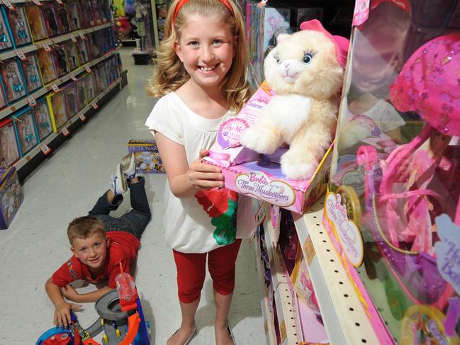 SA child Olivia Mills, 8, of Lockleys, and her brother Lachlan, 6, with Mattel toys from Toys 'R' Us in Adelaide. Mattel are conducting a national search for two children to be trainee toyologists.