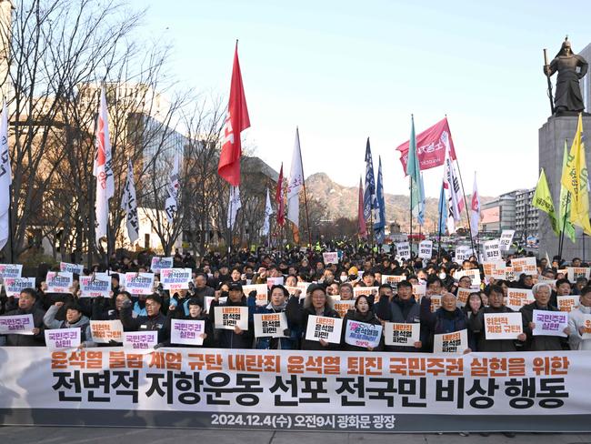 South Korean protesters hold a banner that read ‘we condemn Yoon Suk Yeol's illegal martial law’ during a rally against President Yoon Suk Yeol. Picture: AP