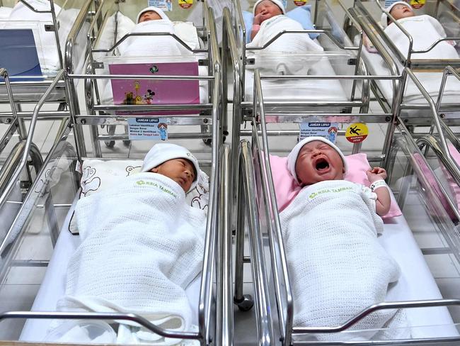 (FILES) Newborn babies inside a ward at the Tambak Maternity Hospital in Jakarta, on September 19, 2022. Babies born by cesarean section don't acquire the same healthy bacteria as those delivered vaginally, a setback to the development of their immune system thought to increase their risk of certain diseases later in life. But a new study, published on June 15, 2023, in the journal Cell Host & Microbe, finds that applying the mother's vaginal fluids on C-section babies after birth successfully restores this microbial balance, and has neurodevelopment benefits, too. (Photo by Adek BERRY / AFP)