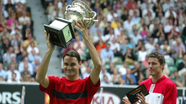 Roger Federer lifts his first Australian Open trophy.