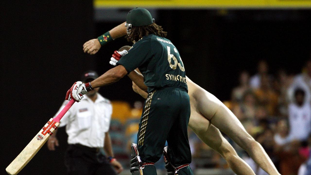 Andrew Symonds clashes with a streaker at the Gabba in 200. Picture: Greg Wood