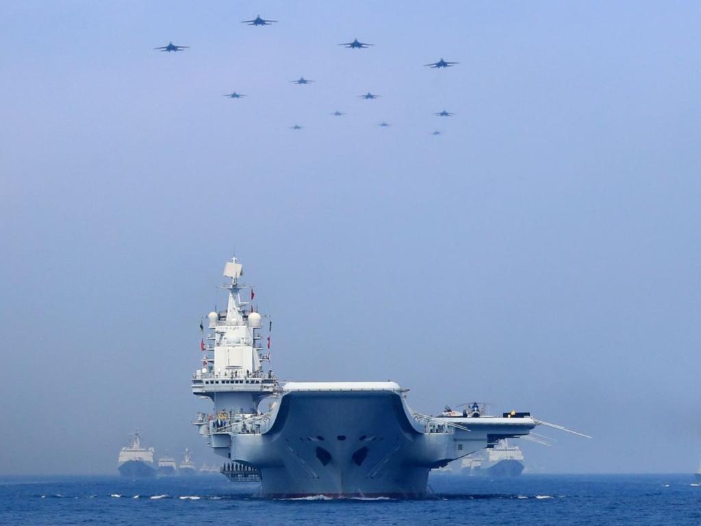 Chinese warships and fighter jets take part in a military display in the South China Sea in April. The standoff between the US and China continues to intensify. Picture: Xinhua