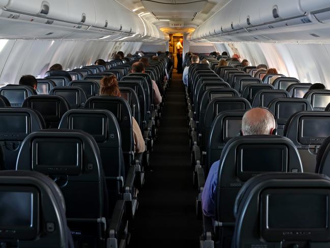 Coronavirus fears have impacted travelers within Australia with Qantas canceling services and the domestic airport nearly empty during Tuesday afternoon. A near empty plane on a flight from Sydney to Melbourne at 3:30pm in the afternoon.  This particular flight would normally be filled by passengers from international flights transferring from Sydney and people getting off cruise ships, both of which have been impacted heavily by the virus.  Picture: Toby Zerna