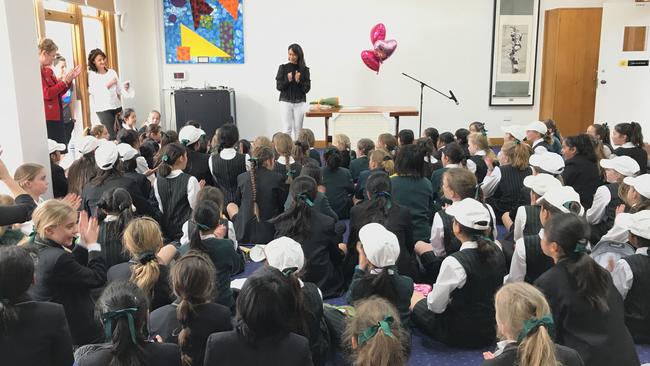 Marie Ramos addressing a school about her charity work. In 2017, Ramos started a campaign with ‘Love Your Sister’ which used ceramics to raise over $100,000 for cancer research. Picture: Supplied