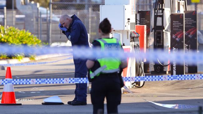 Police photograph evidence at the scene. Picture: David Crosling