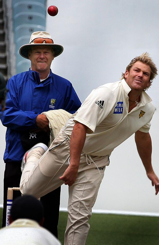 Bruce Oxenford umpiring as Shane Warne bowls.