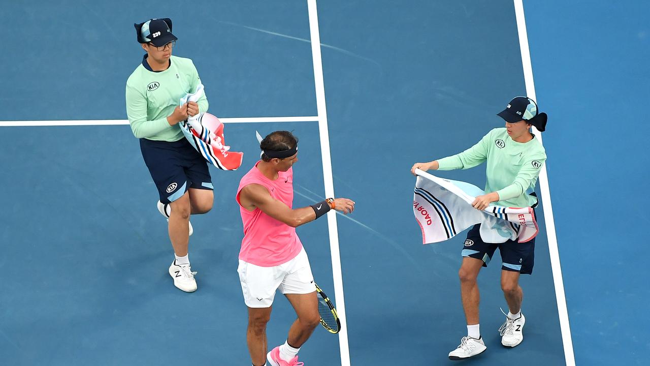 Rafael Nadal receives towels from ballkids during his fourth round match.
