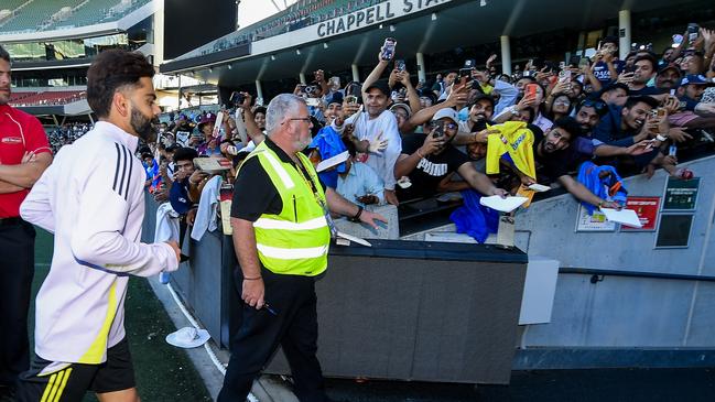 Virat Kohli of India, heads to the nets past adoring fans during an India Test Squad training session at Adelaide Oval on December 3. (Photo by Mark Brake/Getty Images)