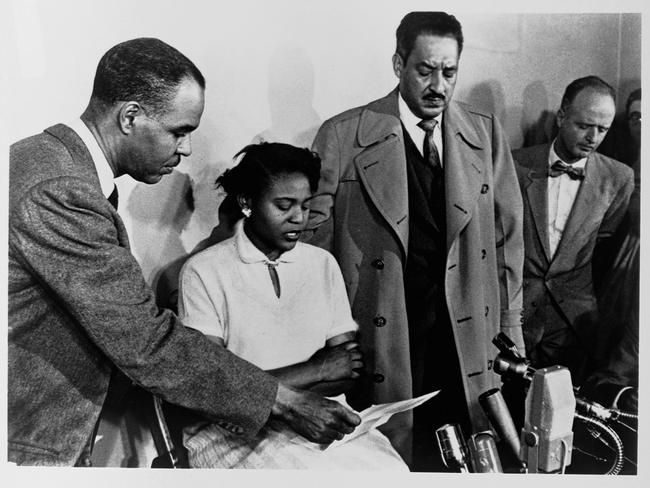 Roy Wilkins, Director of the National Association for the Advancement of Colored People, holds a piece of paper for Autherine Lucy as she speaks at a press conference along with Thurgood Marshall, attorney and Special Counsel for the NAACP Legal Defense and Education Fund. New York, New York.   (Photo by Library of Congress/Corbis/VCG via Getty Images)