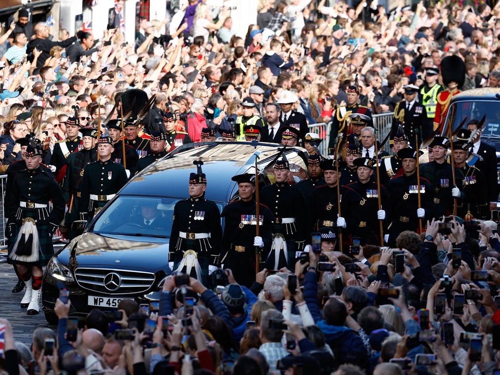 Members of the public gather to watch the procession of Queen Elizabeth II's coffin, from the Palace of Holyroodhouse to St Giles Cathedral, on the Royal Mile in Edinburgh. Picture: Jeff J Mitchell / AFP